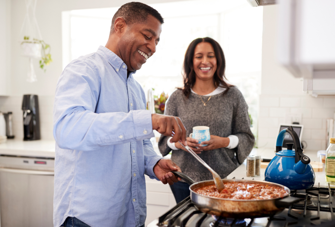 Couple cooking on the stove together