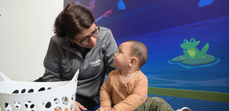 Medical professional with sitting infant