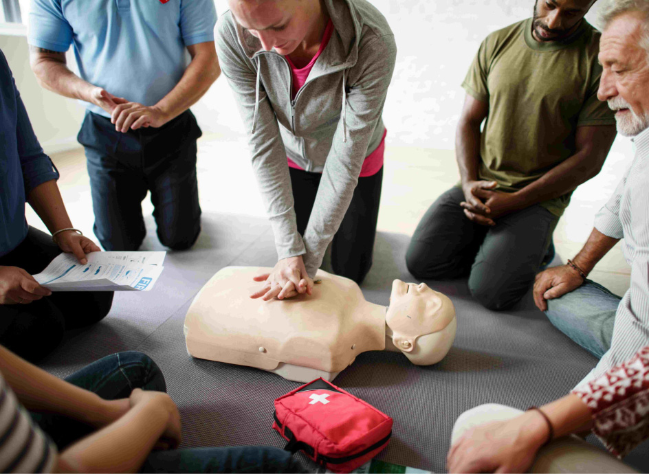 Group of adults practicing CPR