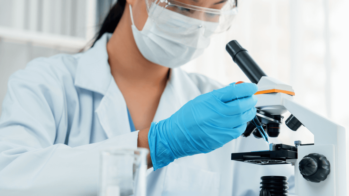 Doctor looking into a microscope