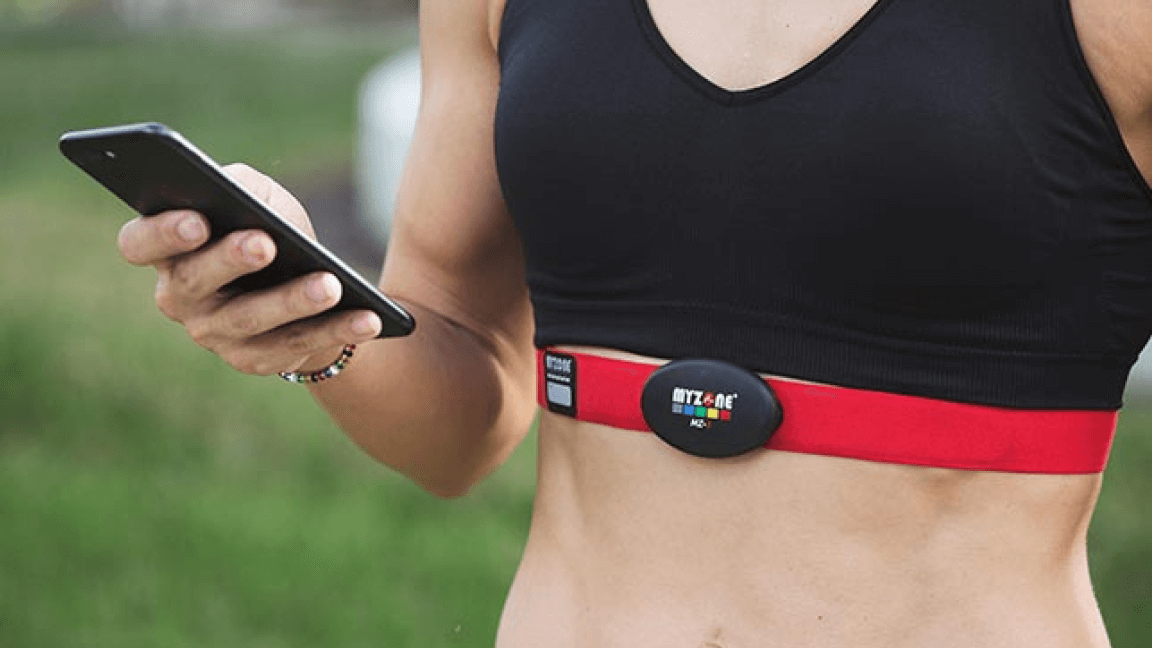 Individual using a chest heart rate monitor