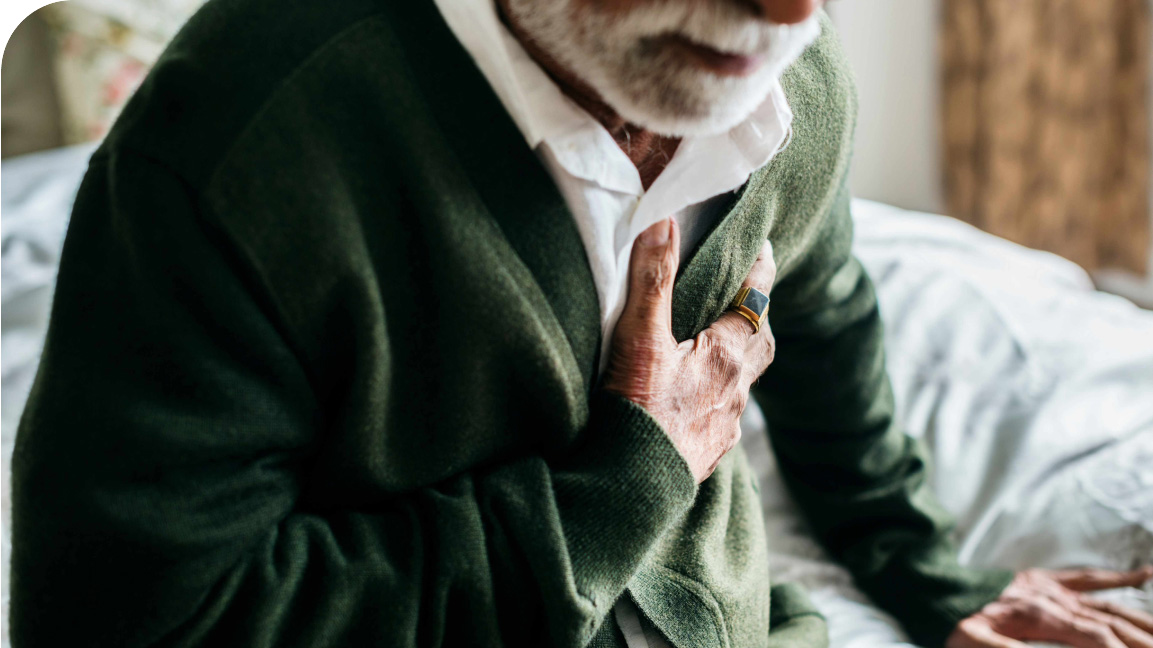Elderly man holding his chest in pain