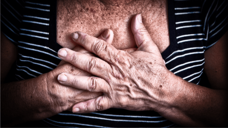 Woman with hands over chest