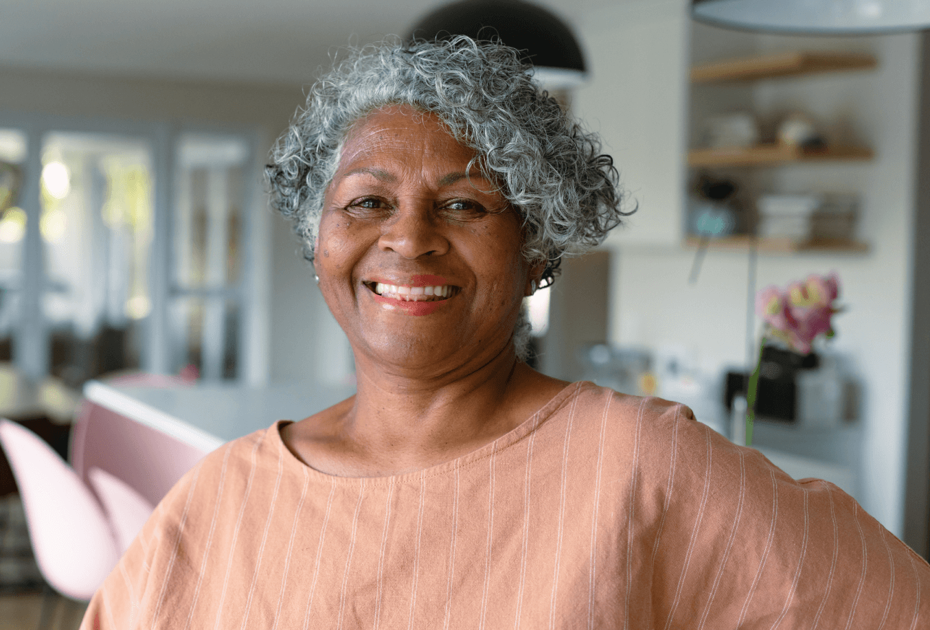 Smiling female inside her kitchen