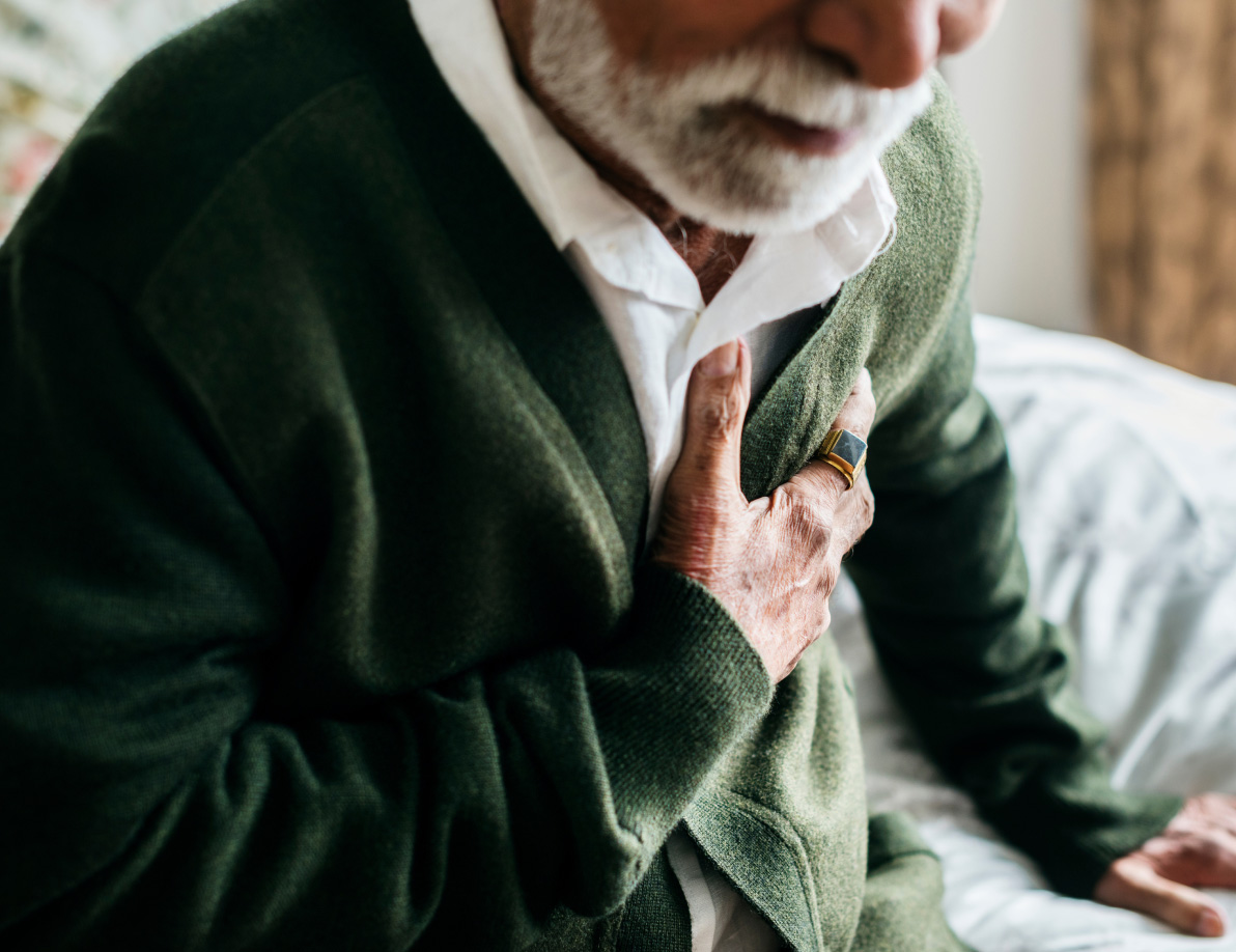 Elderly man grabbing his chest