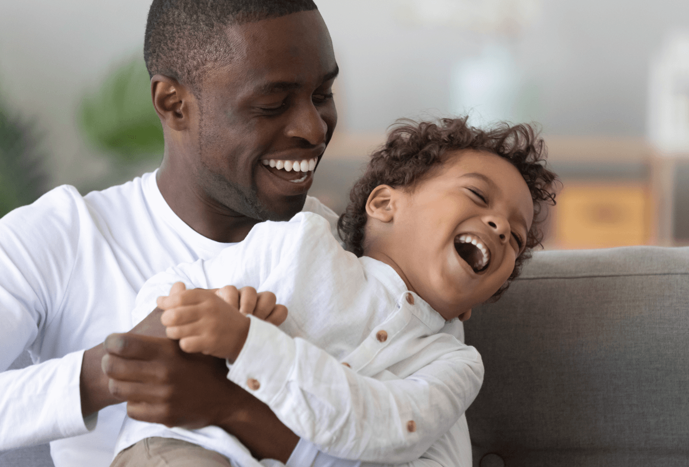 Dad laughing with his toddler