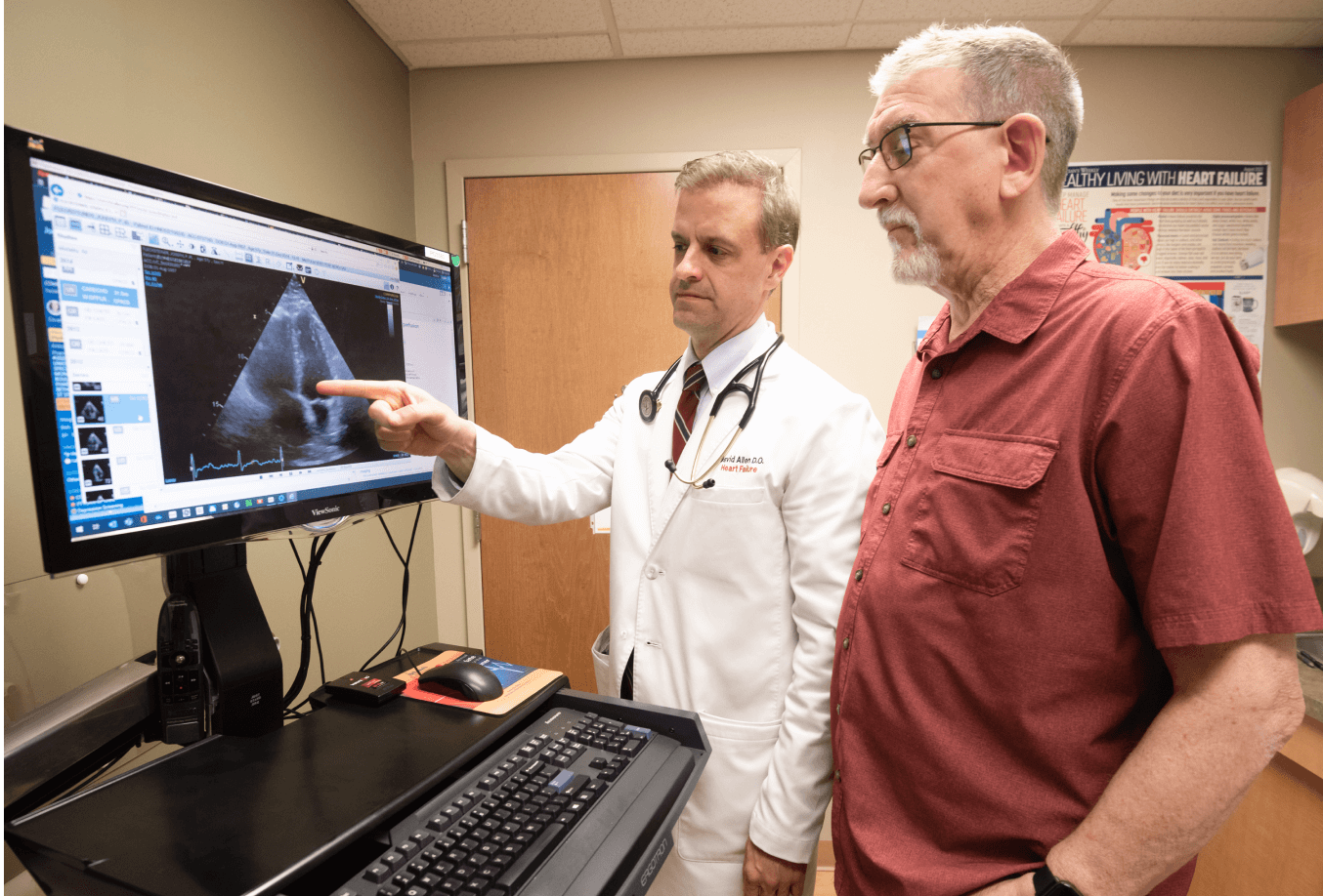 Doctor reviewing data on a computer screen with patient