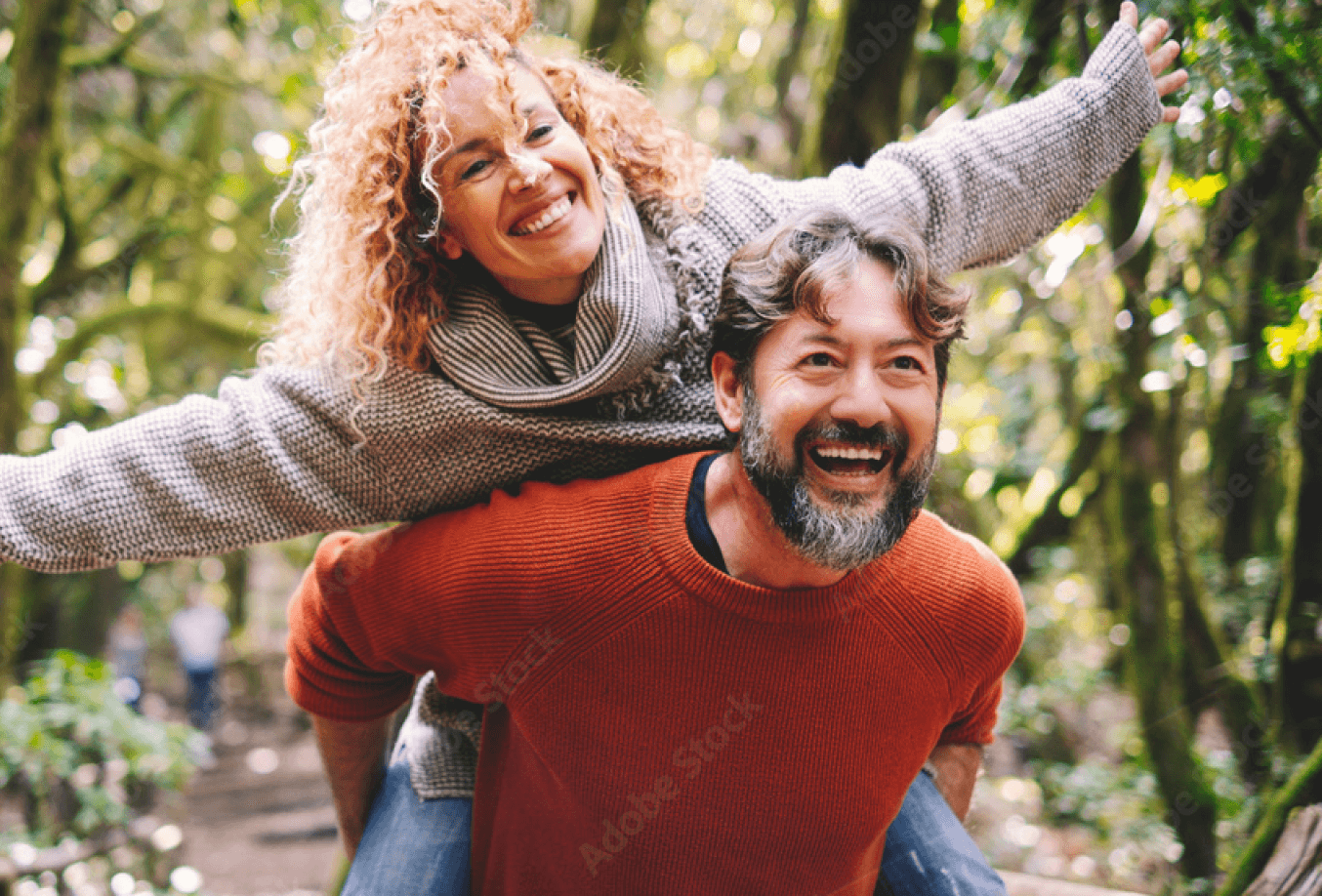 Couple playfully walking through the woods