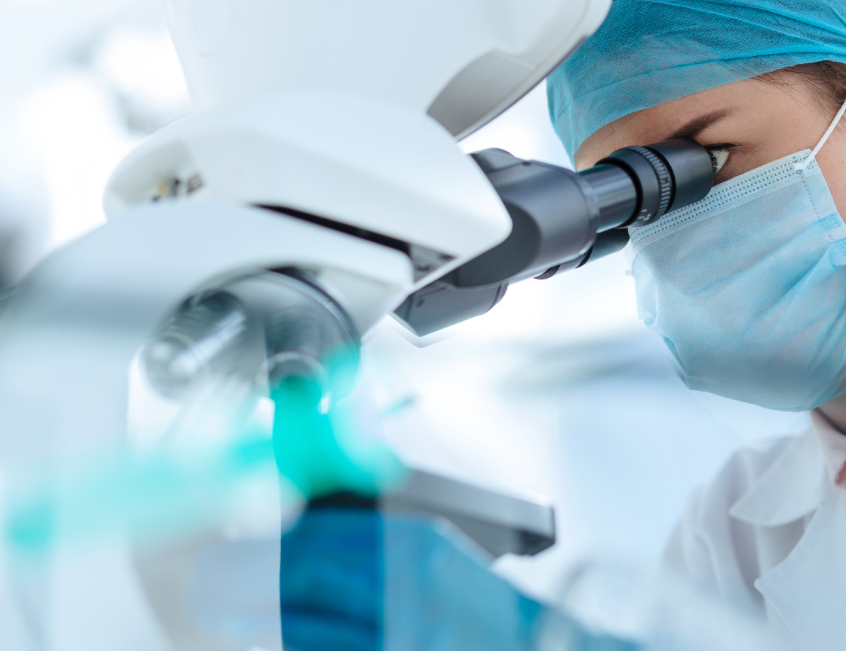 Scientist looking into a microscope