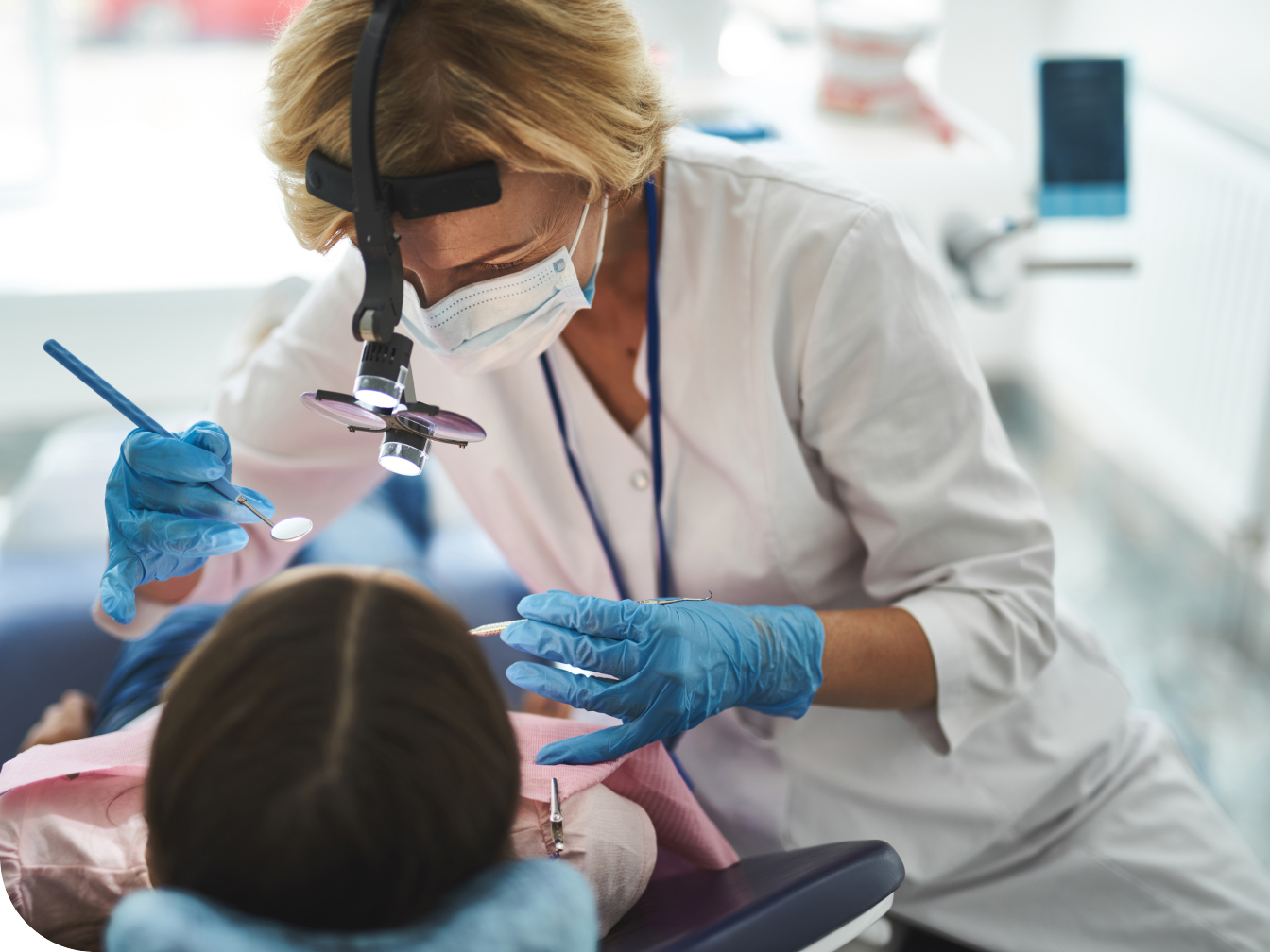 Dentist looking inside of a patient's mouth
