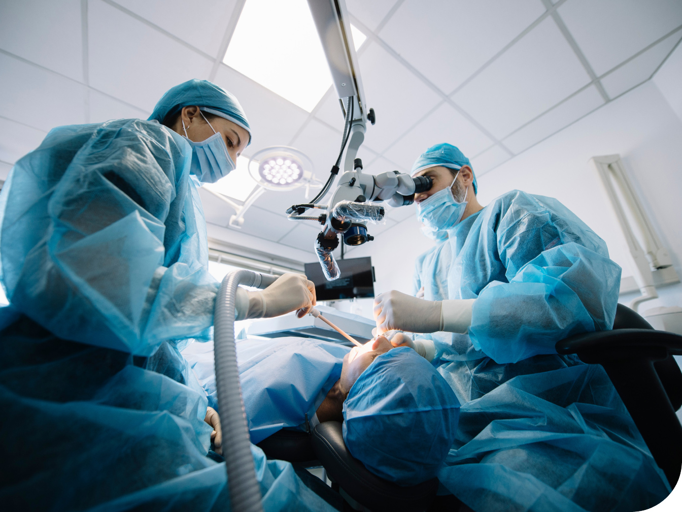 Medical professionals working on a patient's mouth