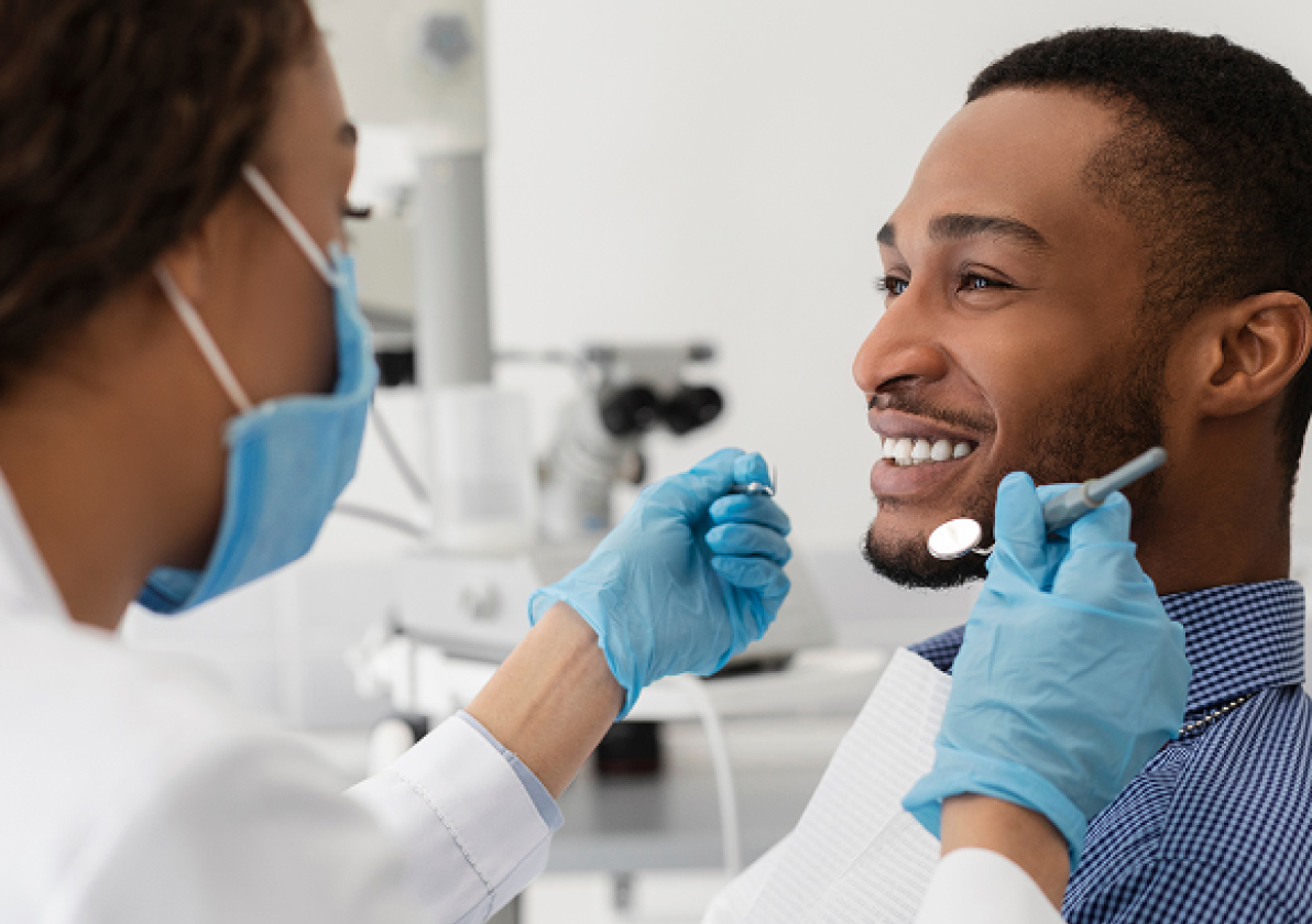 Hygienist talking with smiling patient