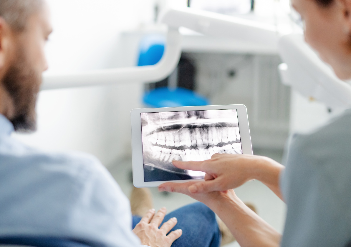 Medical professional going over a patient's dental x-ray