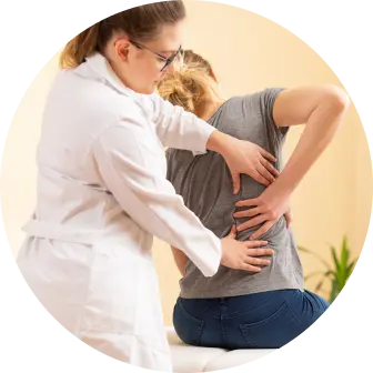 Chiropractor assisting patient