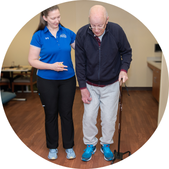 Physical Therapist helping patient stand