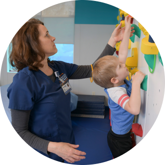 Physical Therapist working with a young child