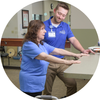 Physical Therapist helping a patient stretch