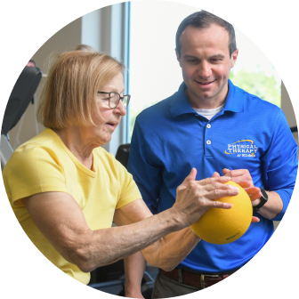 Physical Therapist helping patient with strength