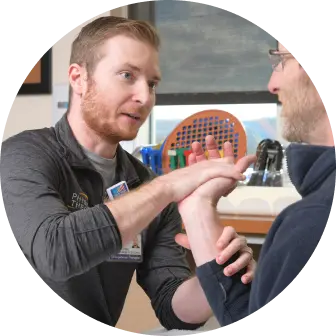 Physical Therapist helping a patient stretch their wrist