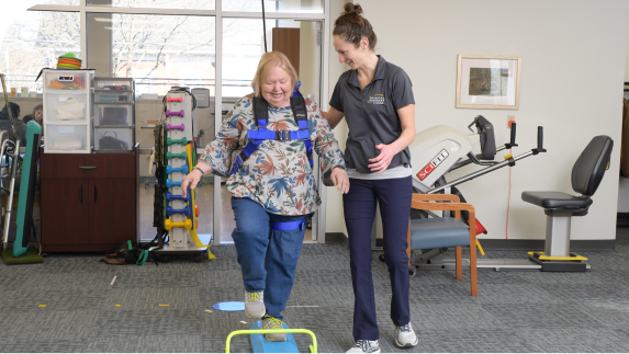 Physical Therapist assisting patient walking