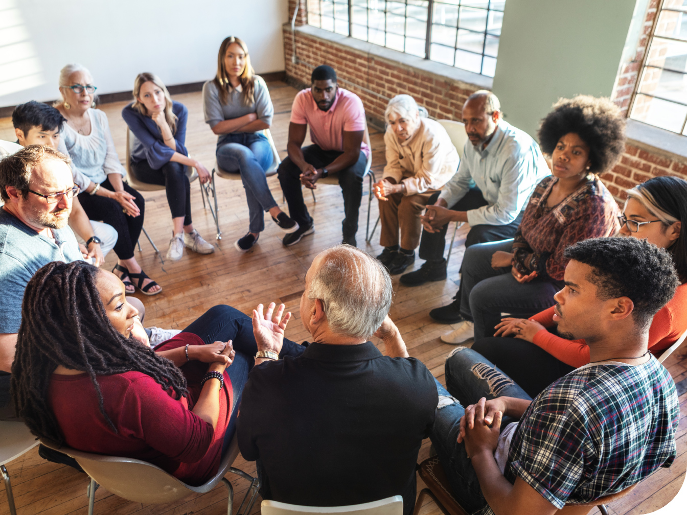 Large group of individuals sitting in a circle