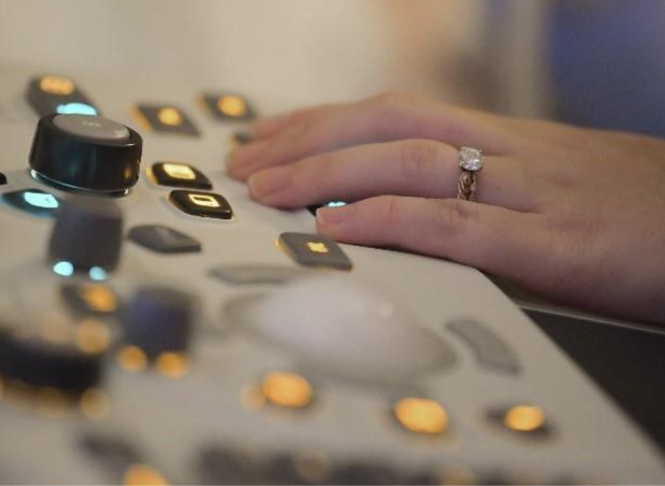 Medical Professional's hand on diagnostic testing equipment