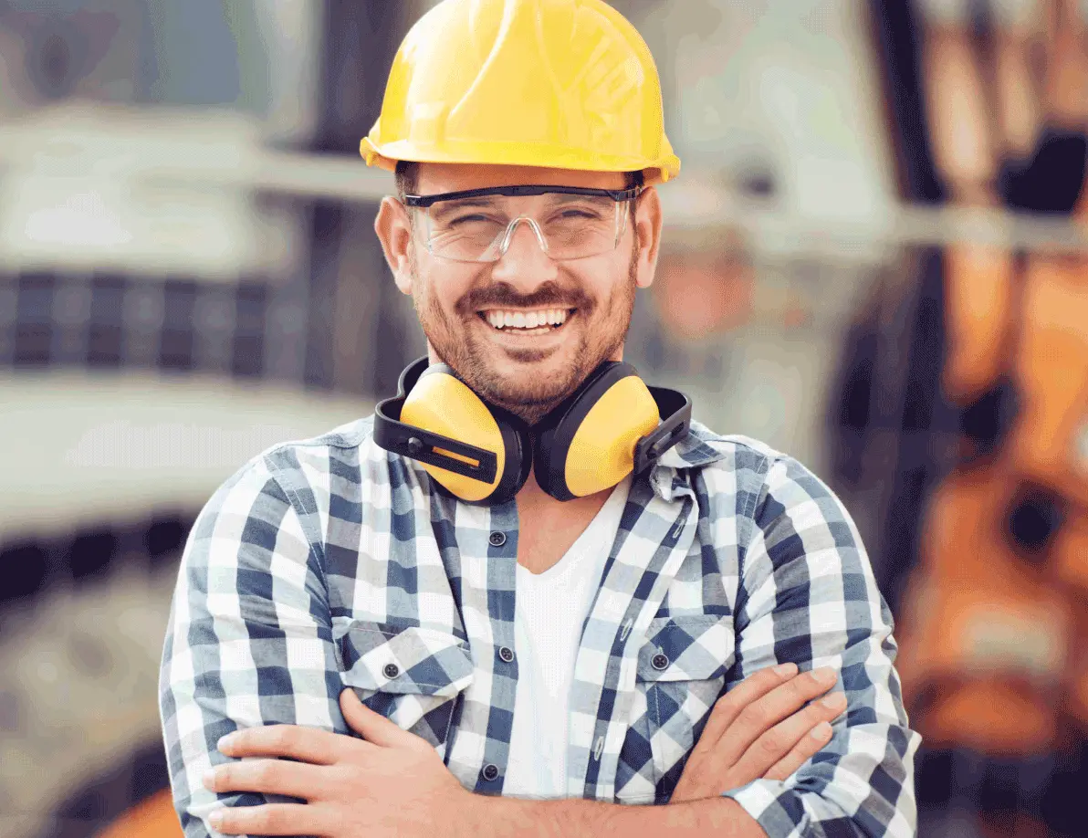 Individual with safety hat, ear protection and vest