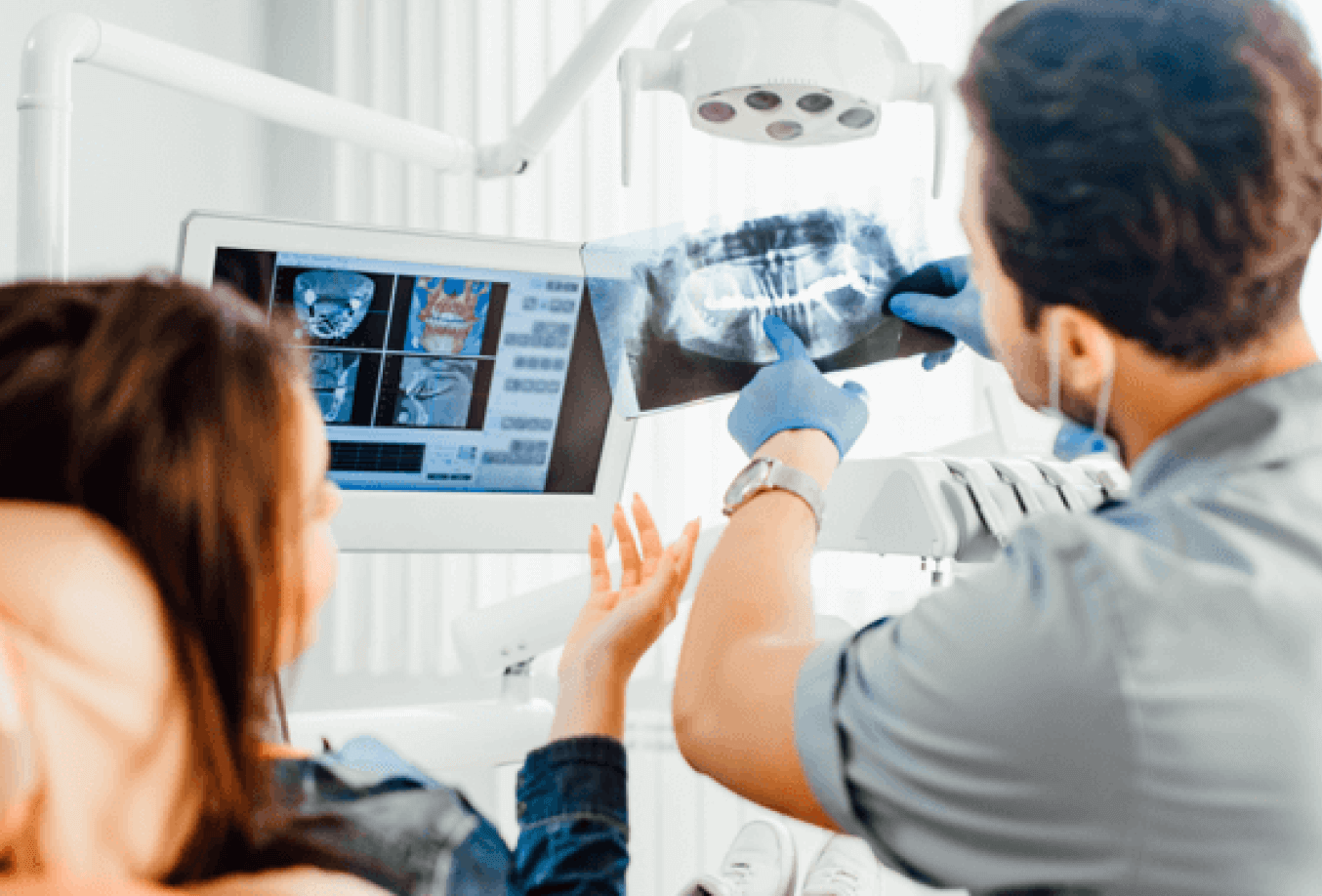 Dentist and patient looking at dental x-rays