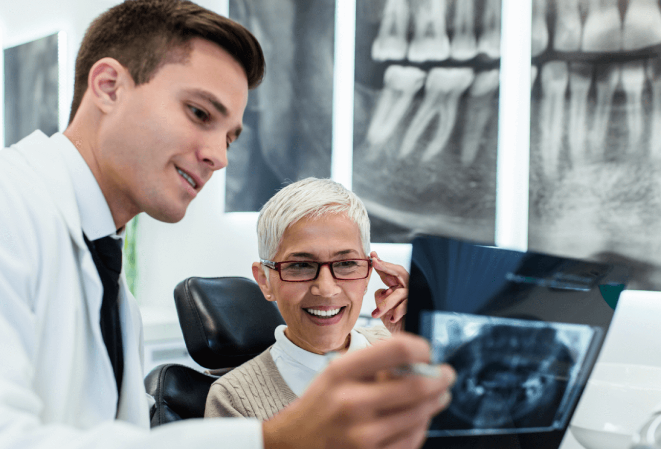 Dentist and patient looking at dental x-rays