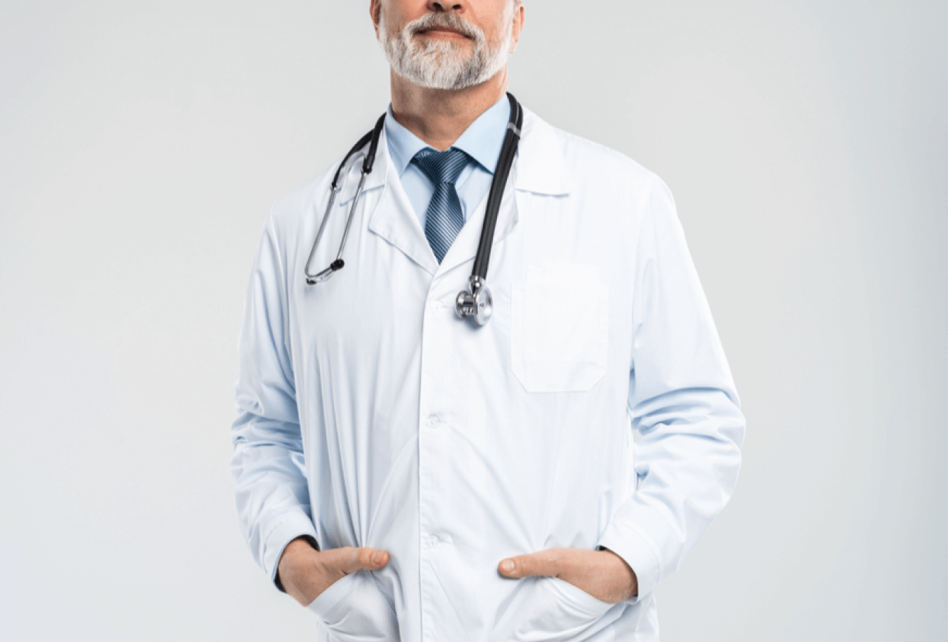 Doctor posing with hands in his pockets