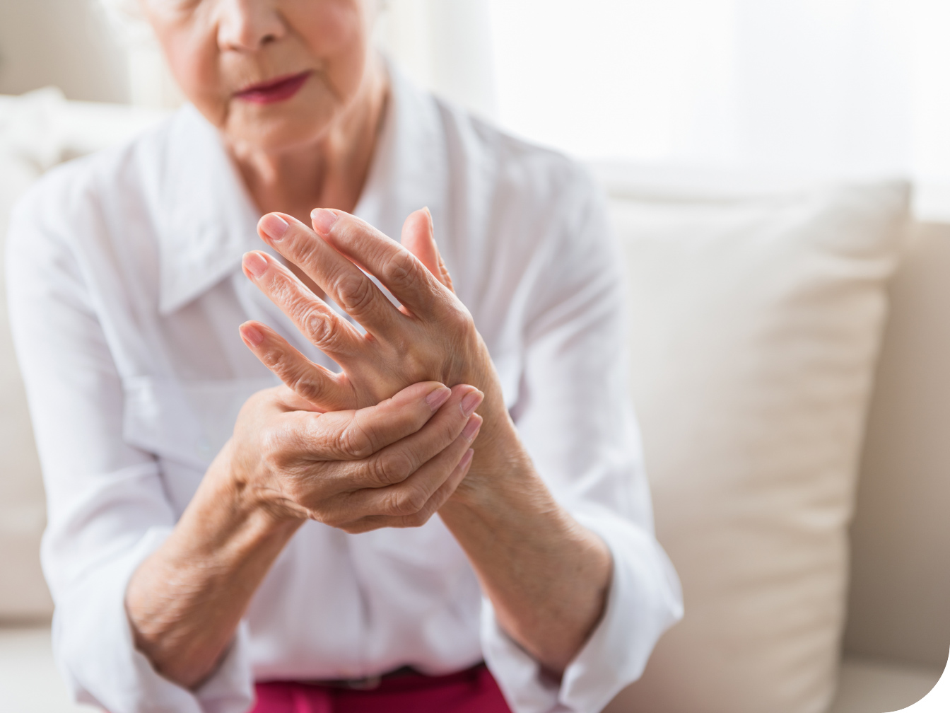 Elderly individual holding their hand in pain