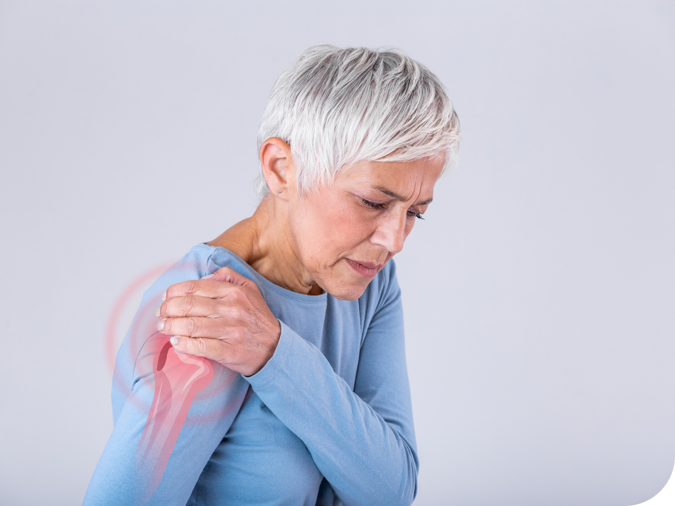 Elderly woman holding a painful shoulder