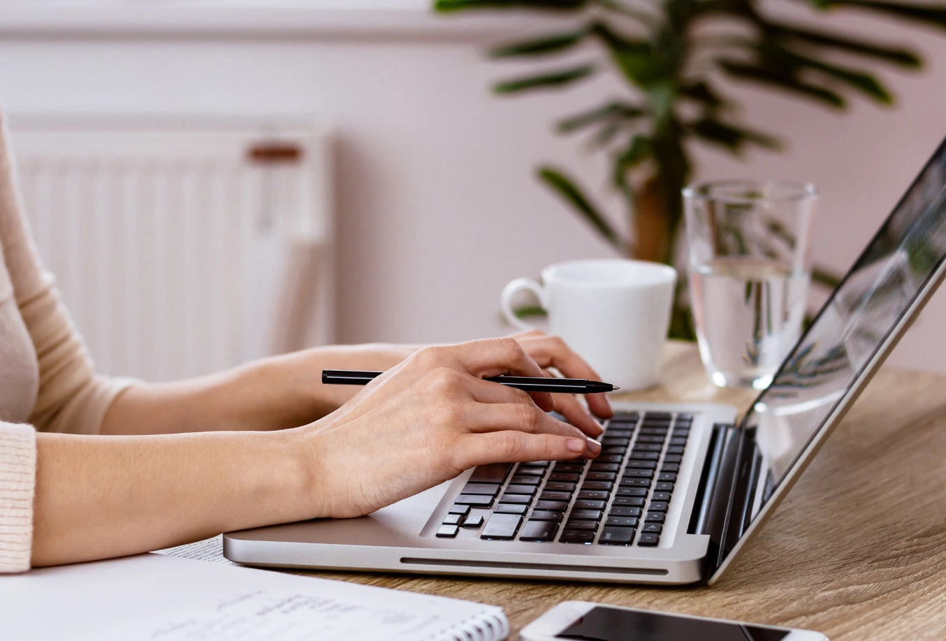 female typing on laptop computer