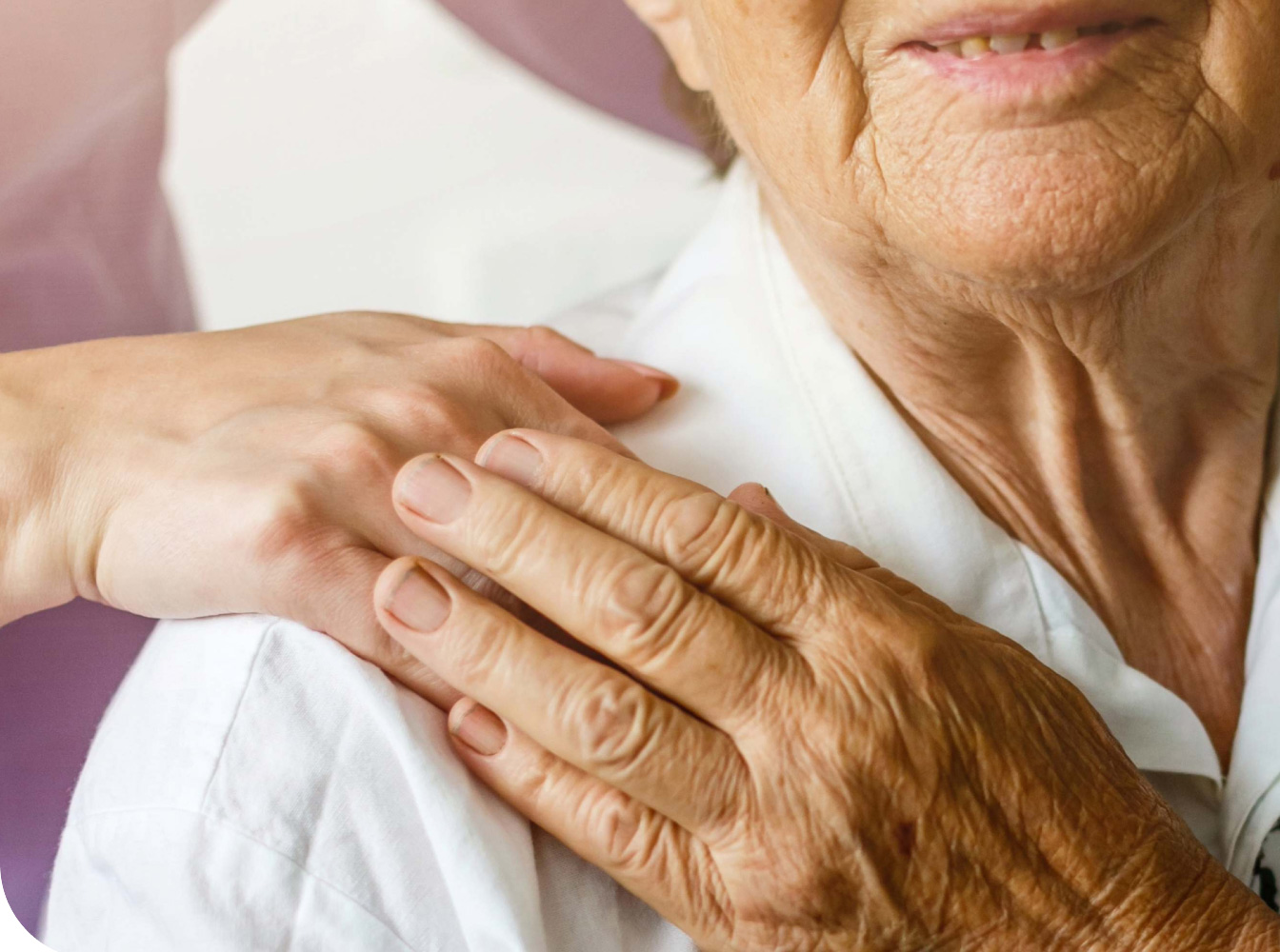 Hand on an elderly woman's shoulder