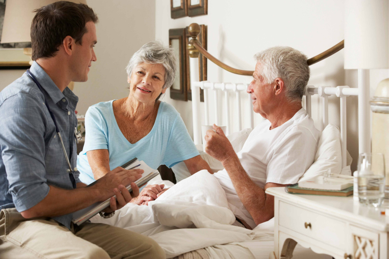 Elderly couple with a medical professional