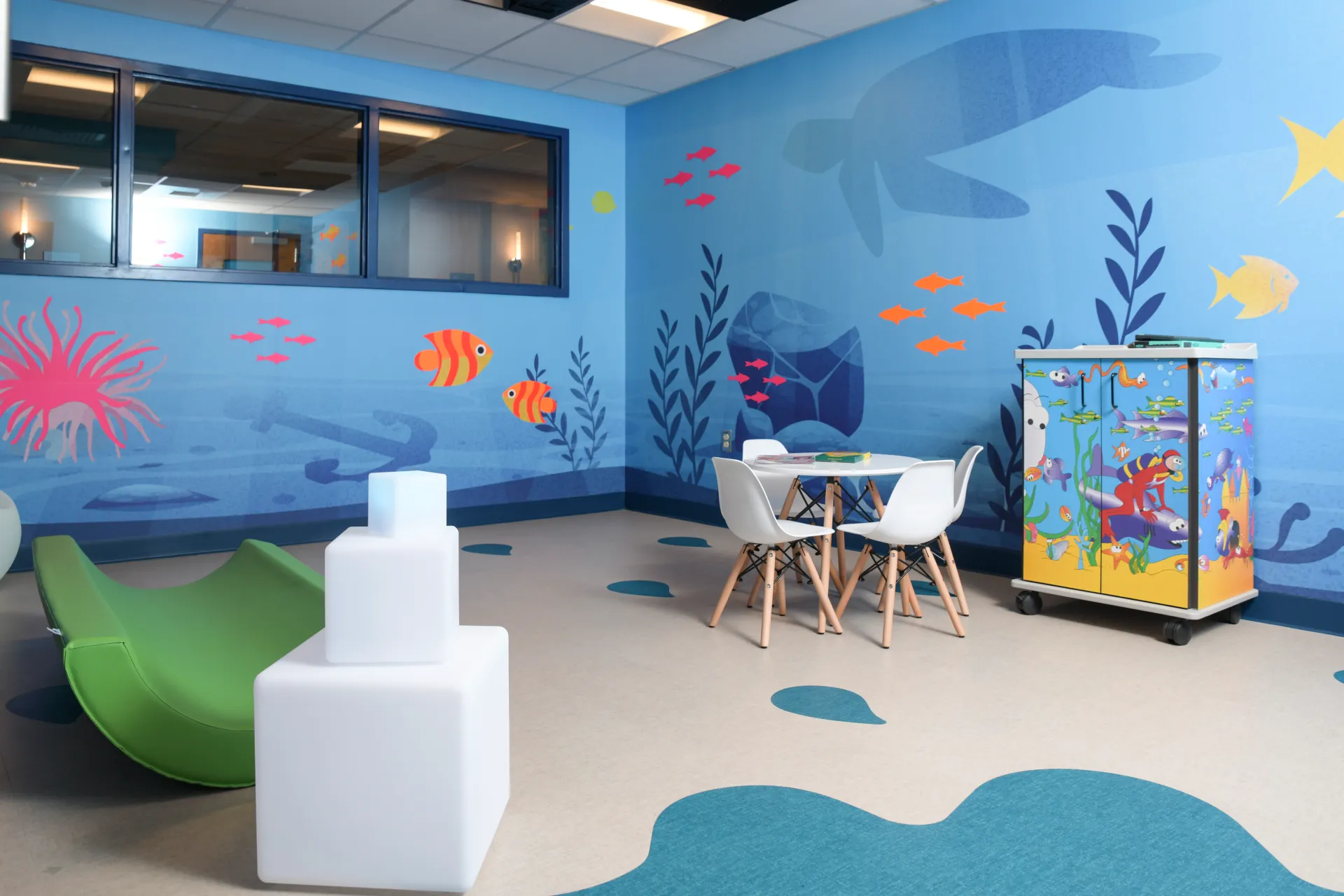 Hospital room with colorful underwater cartoons painted on the walls