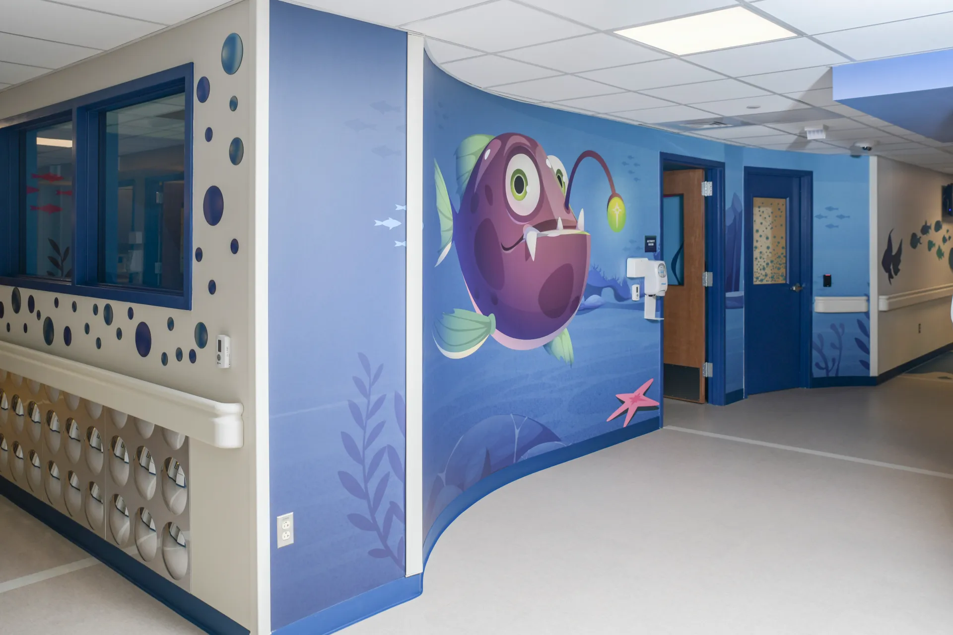 Hospital hallway with colorful fish painted on the walls