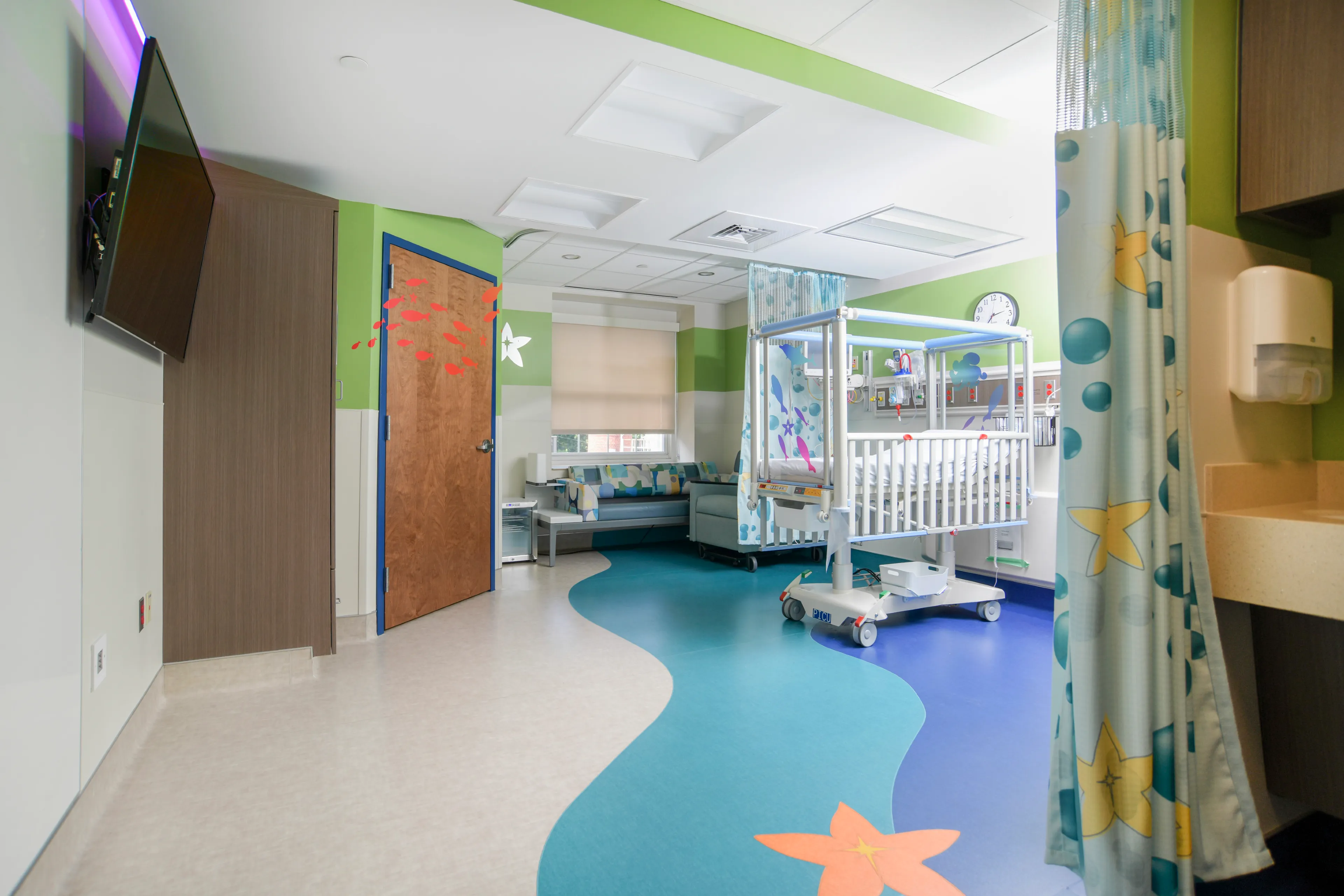 Underwater themed hospital room with a  toddler crib