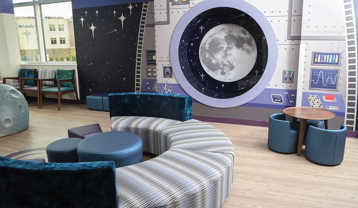 Space themed hospital waiting area with curved couches