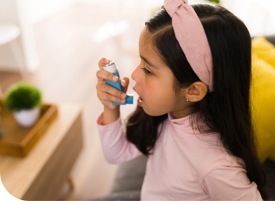 Young girl using an inhaler for asthma
