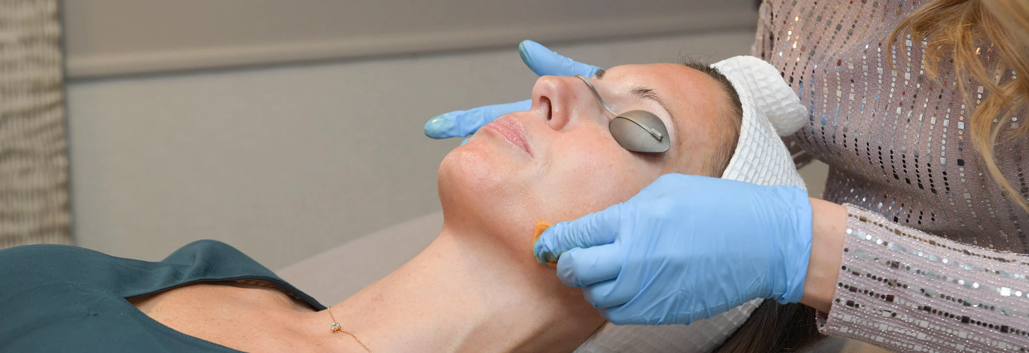 Woman laying down receiving a clinical facial