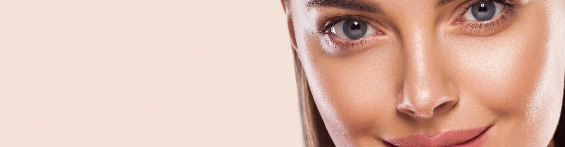 Close up of woman's nose, eyes and smiling lips