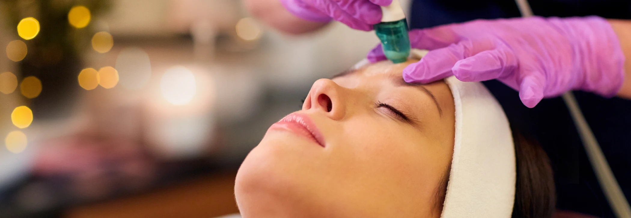 Woman laying down while receiving medical facial treatment