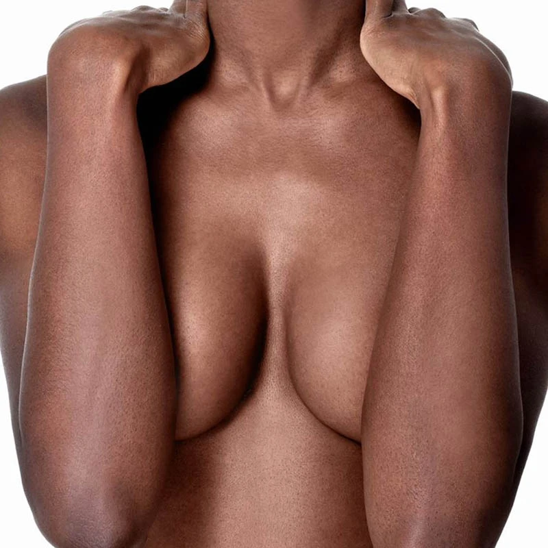 Naked woman's torso holding her breasts