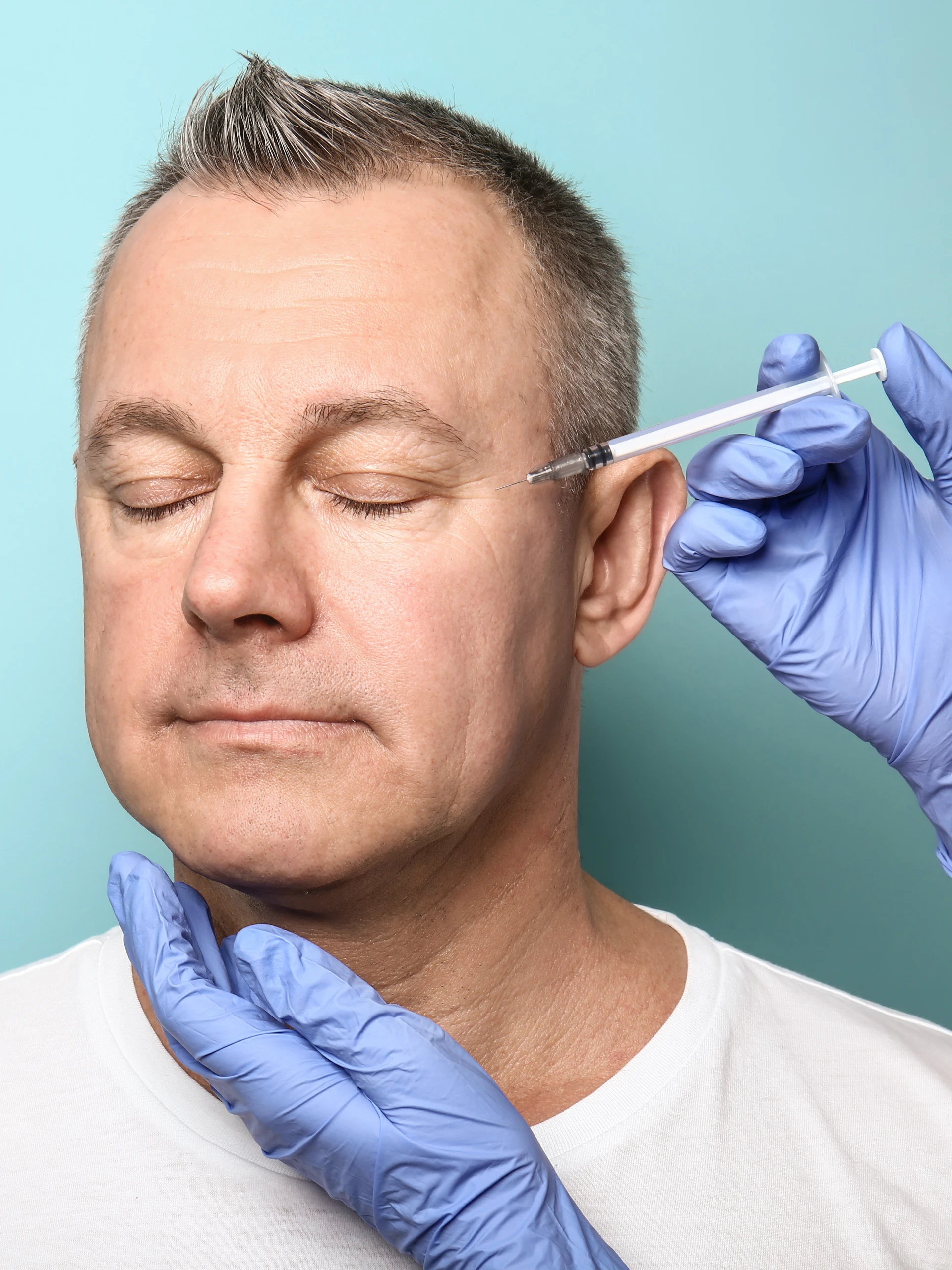 Man's face receiving a Botox injection
