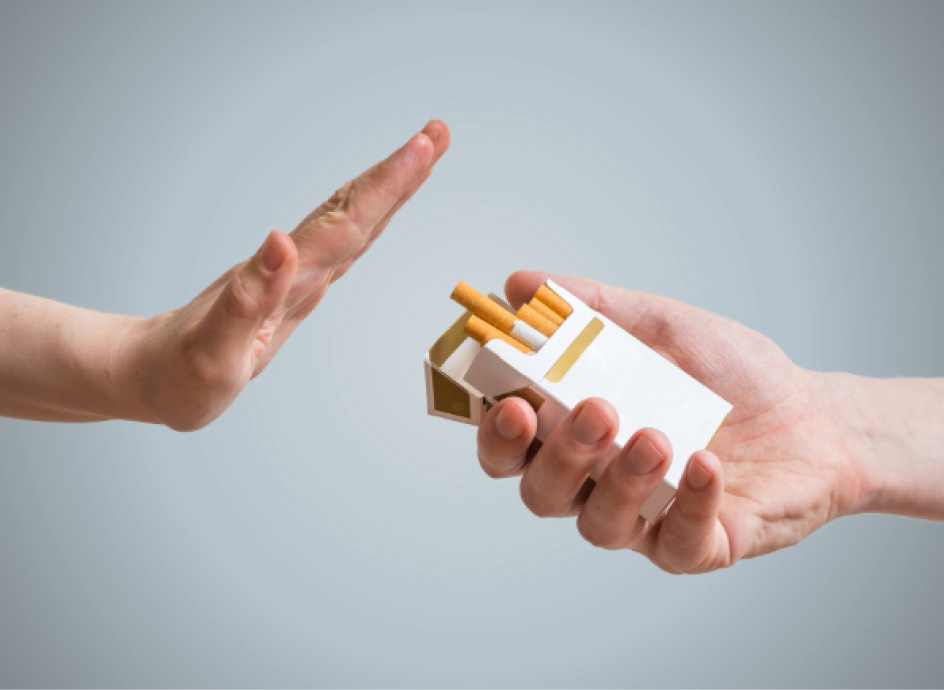 A hand offering cigarettes to another hand