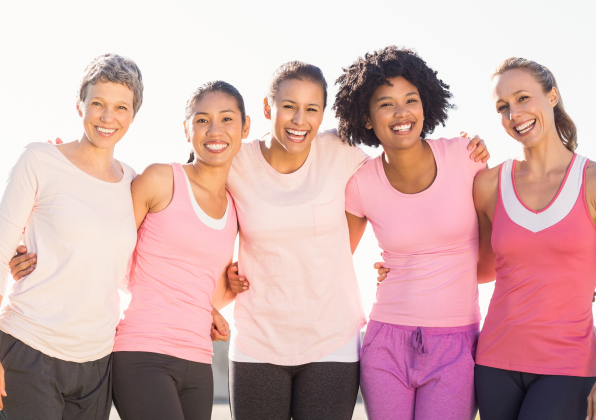 Group of five women holding each other