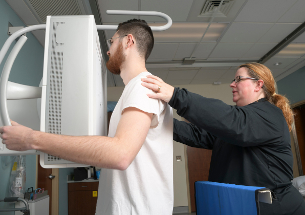Medical Professional assisting a patient with a scan