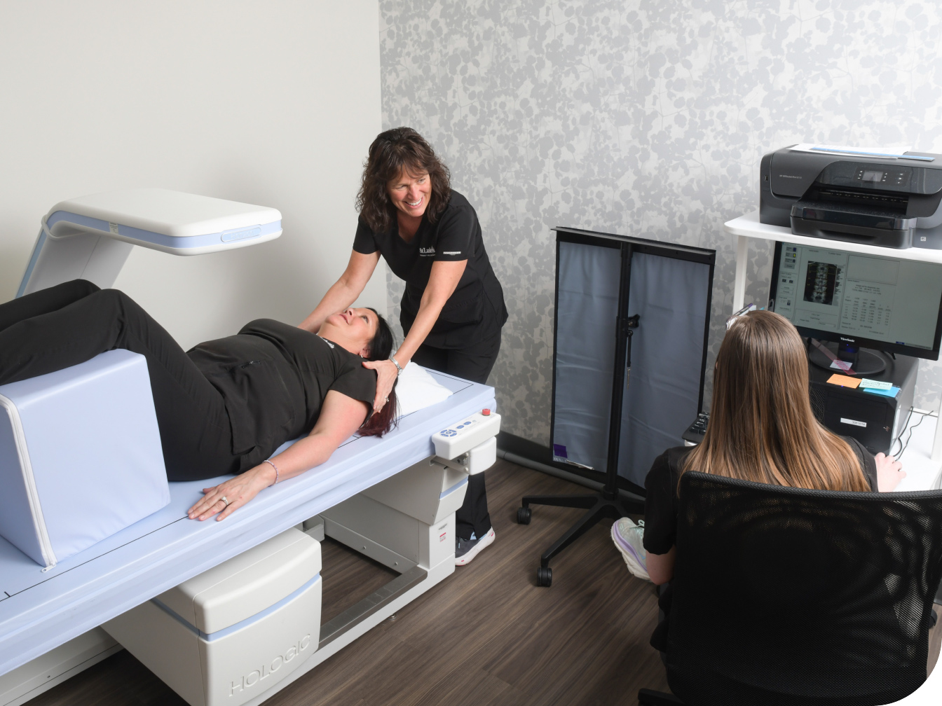Medical Professional assisting a patient with a DEXA Scan