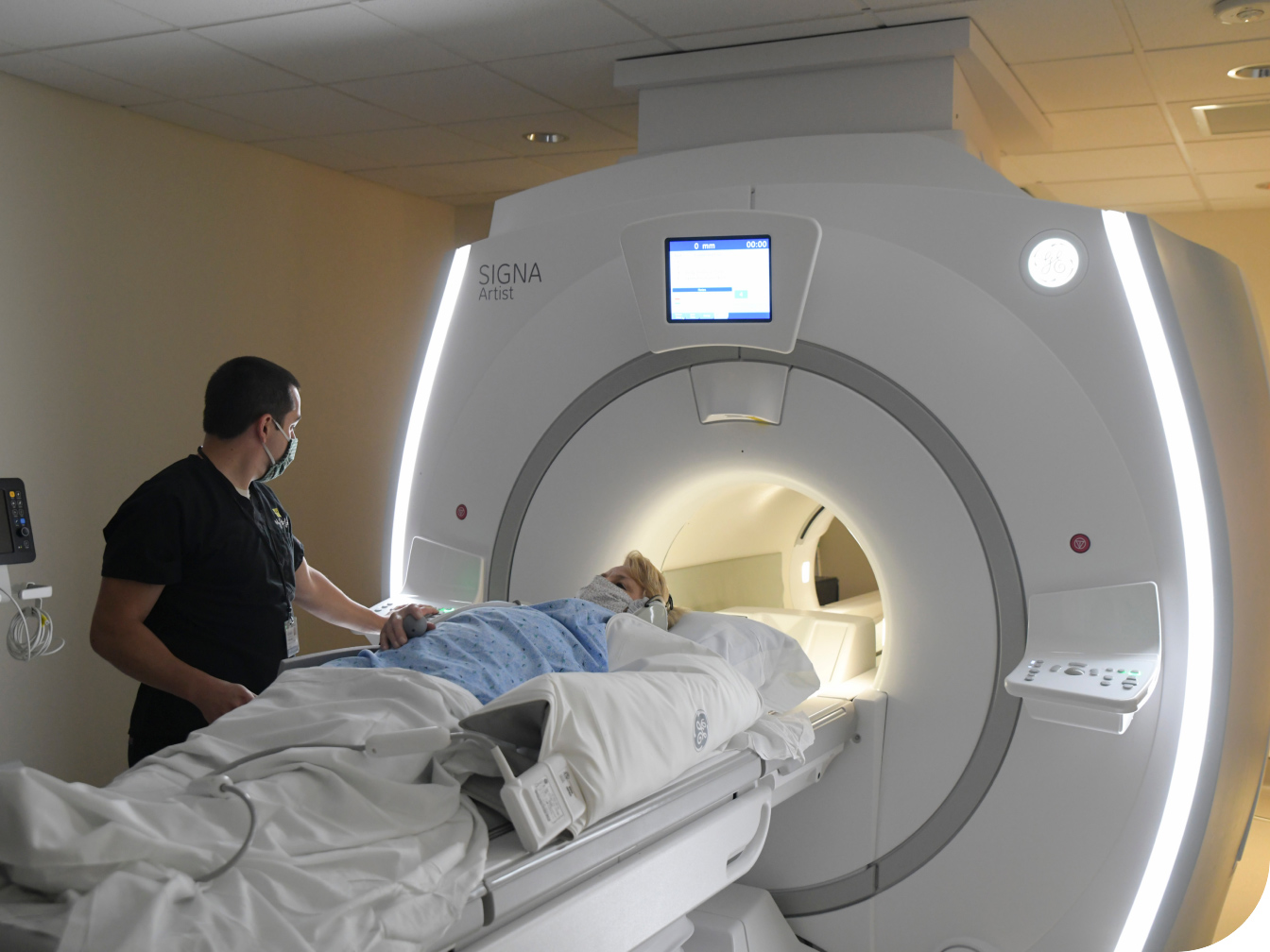 Medical Professional assisting patient in MRI machine